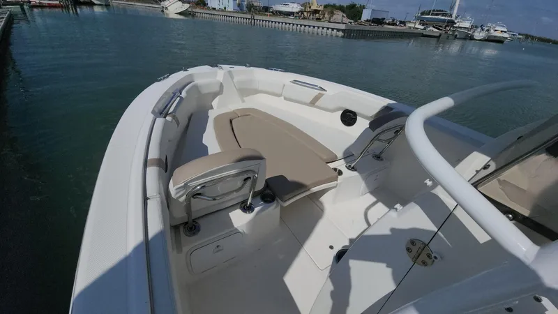 Slide: The Image of 2014 Striper 220 Center Console boat interior with seating, docked in a marina. - 3