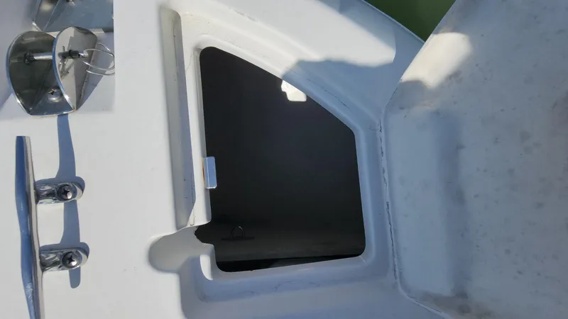 Slide: The Image of Open storage compartment on a 2014 Striper 220 Center Console boat. - 31