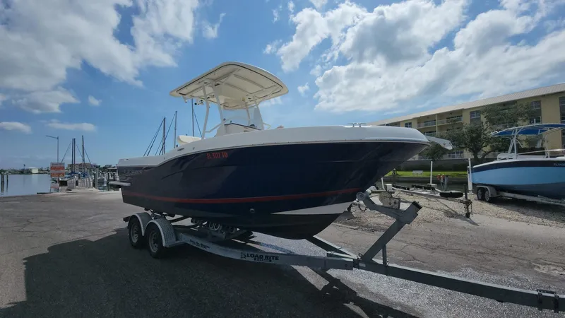 Slide: The Image of 2014 Striper 220 Center Console boat on trailer under cloudy sky. - 37