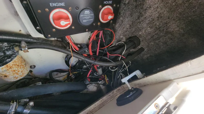 Slide: The Image of 2014 Striper 220 Center Console wiring and battery switches in engine compartment. - 45