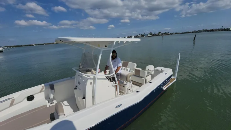 Slide: The Image of 2014 Striper 220 Center Console boat on calm water under a partly cloudy sky. - 47
