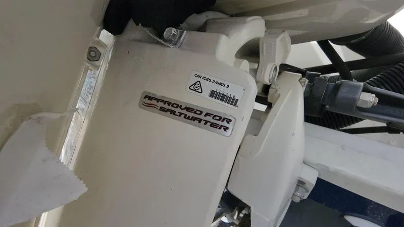 Slide: The Image of 2014 Striper 220 Center Console, approved for saltwater use, close-up of engine component. - 48