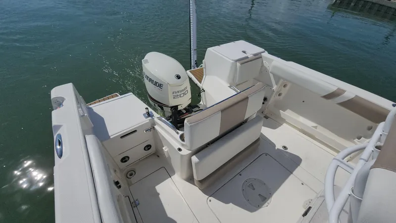 Slide: The Image of 2014 Striper 220 Center Console boat with Evinrude engine on calm water. - 5