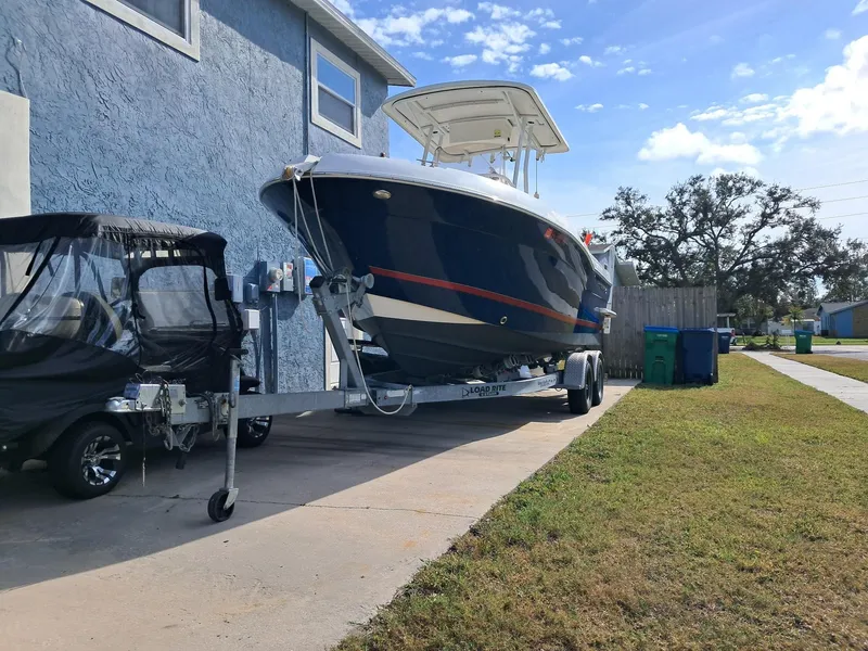 Slide: The Image of 2014 Striper 220 Center Console boat on trailer beside house. - 8