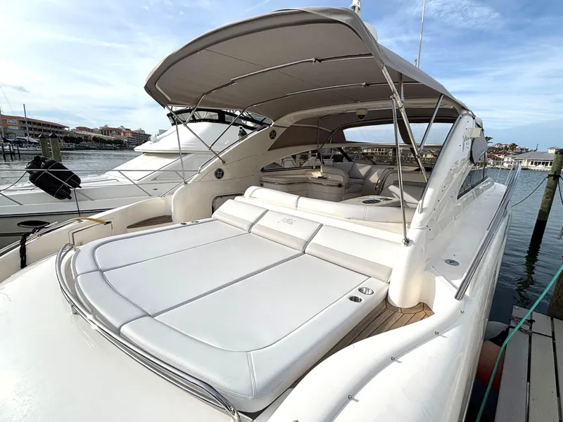 Slide: The Image of 2005 Viking Princess V50 yacht with spacious deck and canopy, docked at marina. - 23