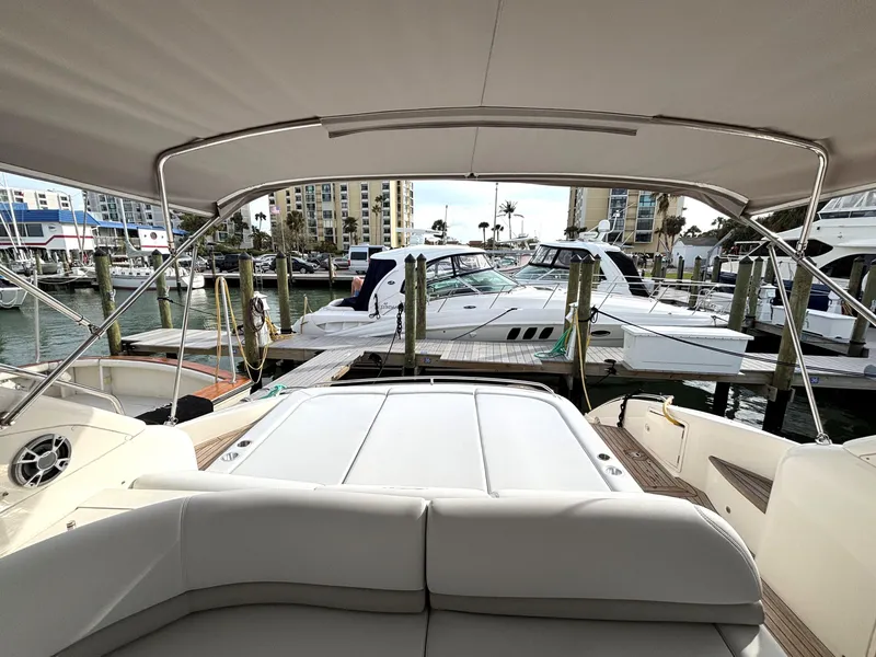 Slide: The Image of 2005 Viking Princess V50 yacht interior view at marina, showcasing luxury seating and docked boats. - 24