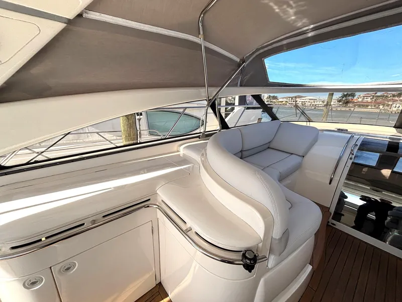 Slide: The Image of 2005 Viking Princess V50 yacht interior with white seating and wood flooring. - 35