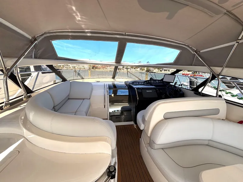 Slide: The Image of Luxurious 2005 Viking Princess V50 yacht interior with white seating and helm. - 36