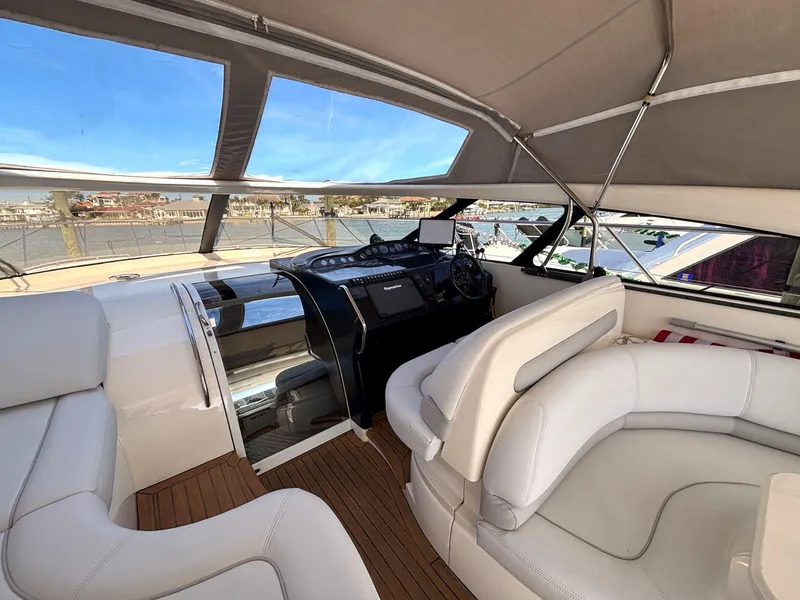Slide: The Image of Luxurious 2005 Viking Princess V50 yacht interior with white leather seating and modern helm. - 39