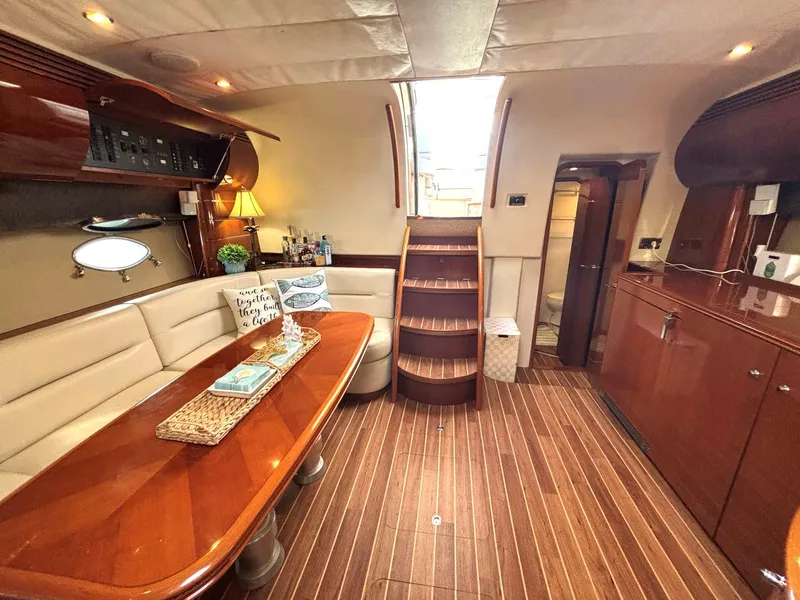 Slide: The Image of Luxurious 2005 Viking Princess V50 yacht interior with elegant wood finishes and cozy seating area. - 46