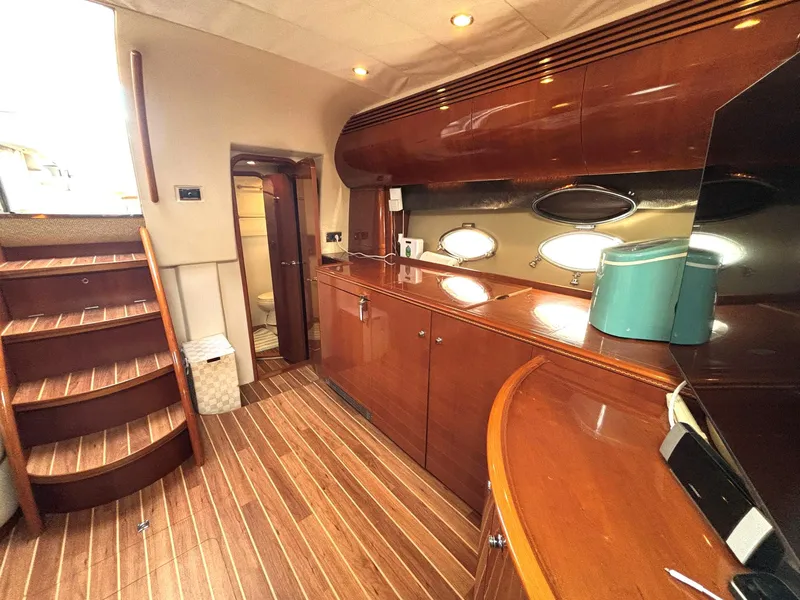 Slide: The Image of Luxurious 2005 Viking Princess V50 yacht interior with polished wood finishes and modern amenities. - 49