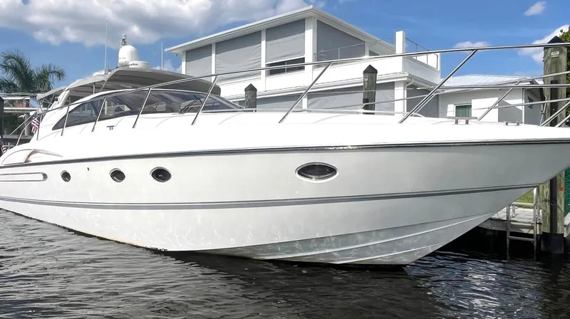 Slide: The Image of 2005 Viking Princess V50 yacht docked by modern waterfront home. - 5