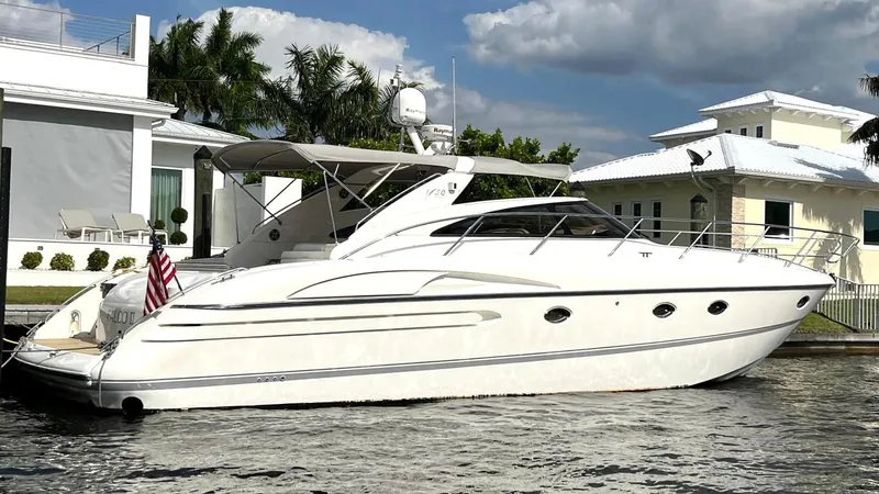 Slide: The Image of Luxury 2005 Viking Princess V50 yacht docked by waterfront homes. - 7