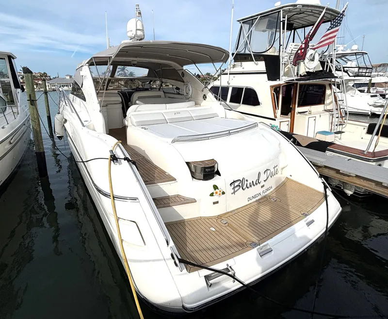 Slide: The Image of 2005 Viking Princess V50 yacht docked at marina, featuring spacious deck and sleek design. - 8