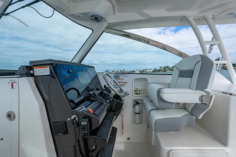 Slide: The Image of 2023 Pursuit DC 295 Dual Console boat interior with modern helm and seating. - 18
