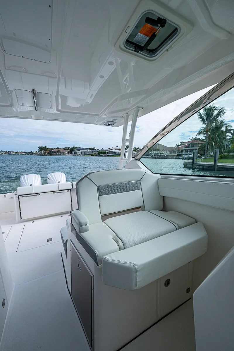Slide: The Image of 2023 Pursuit DC 295 Dual Console boat interior with waterfront view. - 19