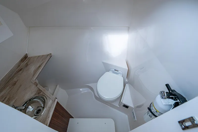 Slide: The Image of 2023 Pursuit DC 295 Dual Console boat bathroom with sink and toilet. - 21