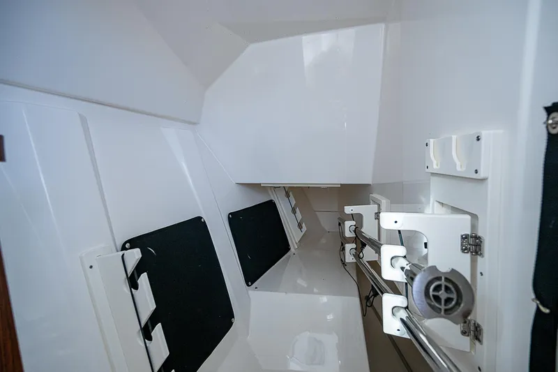 Slide: The Image of Interior view of 2023 Pursuit DC 295 Dual Console boat, showcasing storage compartments. - 22