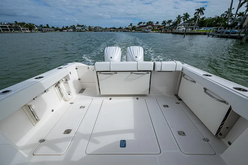 Slide: The Image of 2023 Pursuit DC 295 Dual Console boat on water, spacious deck view. - 23