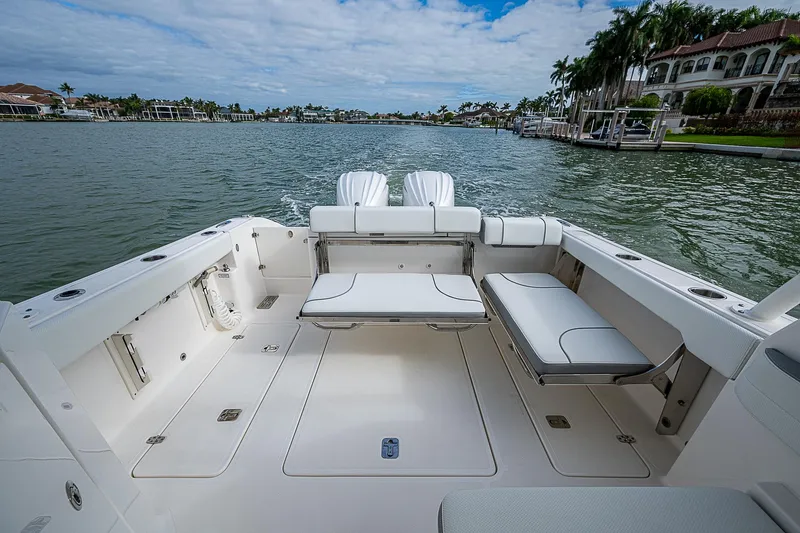 Slide: The Image of 2023 Pursuit DC 295 Dual Console boat on a scenic waterfront. - 24