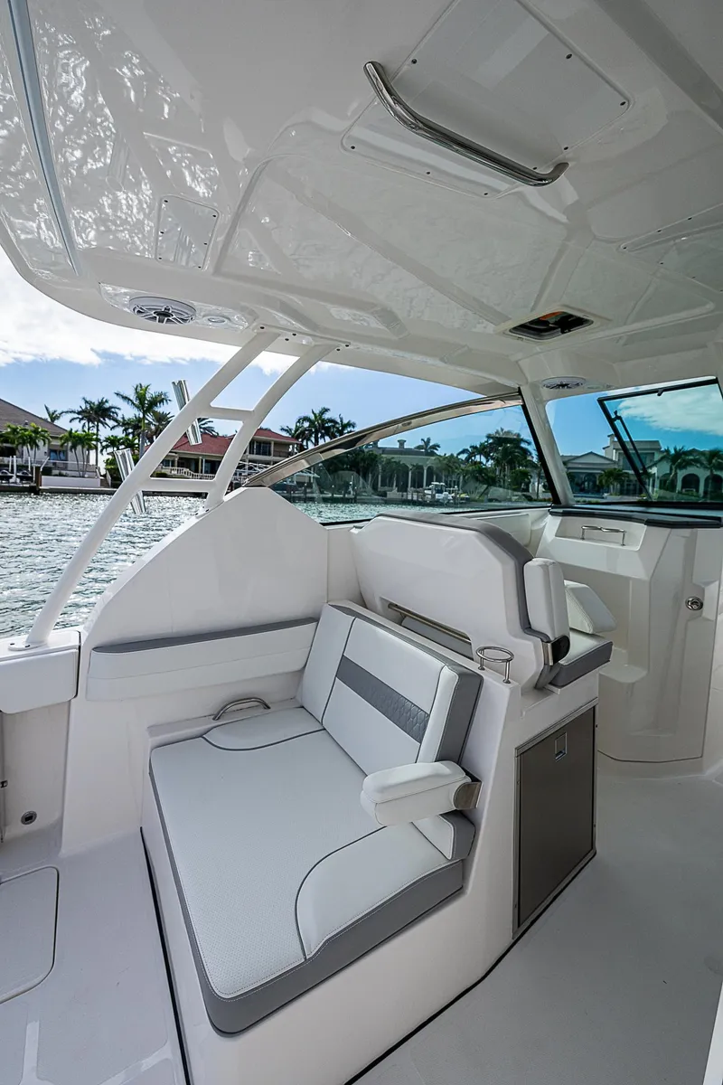 Slide: The Image of 2023 Pursuit DC 295 Dual Console boat interior with sleek seating and modern design. - 26