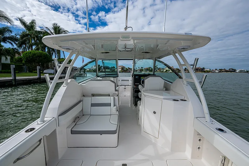 Slide: The Image of 2023 Pursuit DC 295 Dual Console boat interior on a sunny day. - 28