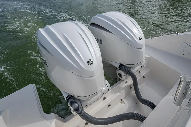 Slide: The Image of 2023 Pursuit DC 295 Dual Console with twin Yamaha outboard engines on water. - 31