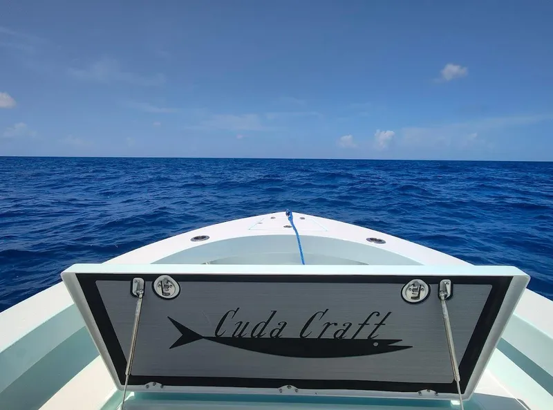 Slide: The Image of Cuda Craft 19 boat on open ocean, 2025 model, under clear blue sky. - 12