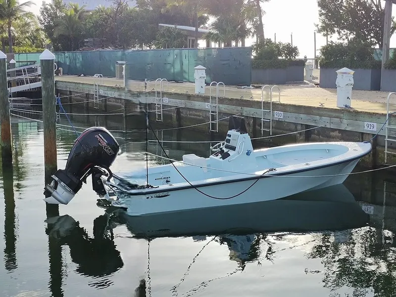 Slide: The Image of 2025 Cuda Craft 19 boat docked in a serene marina setting. - 4