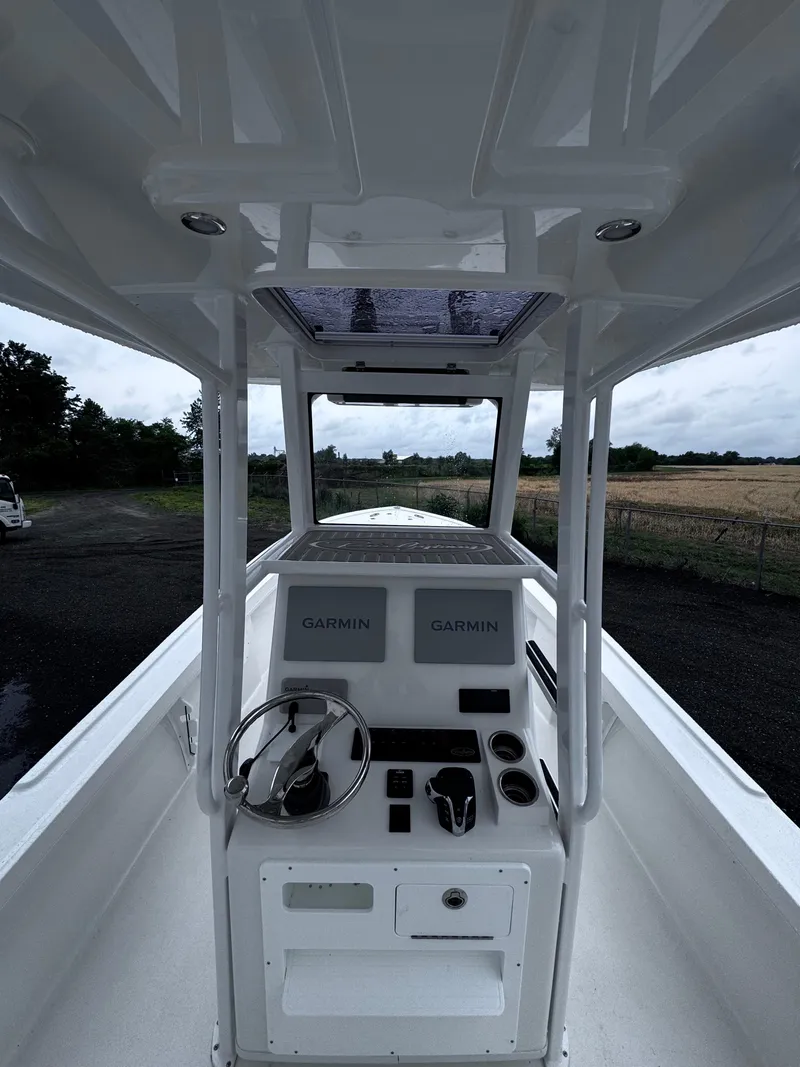 Slide: The Image of 2025 Pair Customs 24DV boat interior with Garmin navigation system, steering wheel, and control panel. - 10