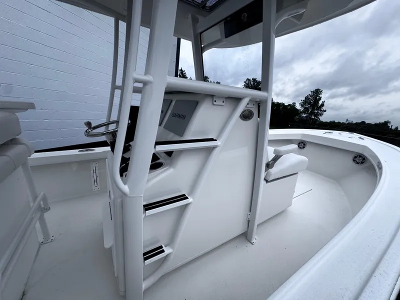 Slide: The Image of 2025 Pair Customs 24DV boat interior with sleek white design and modern console. - 16