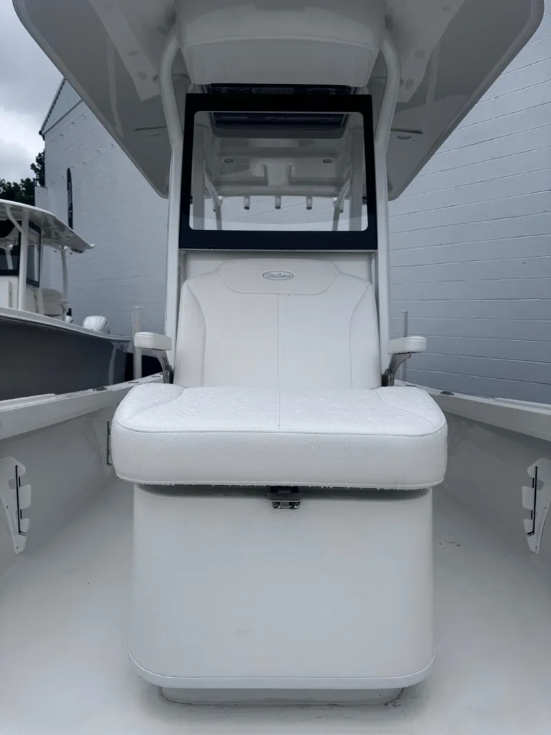 Slide: The Image of 2025 Pair Customs 24DV boat with white seating and modern design. - 11