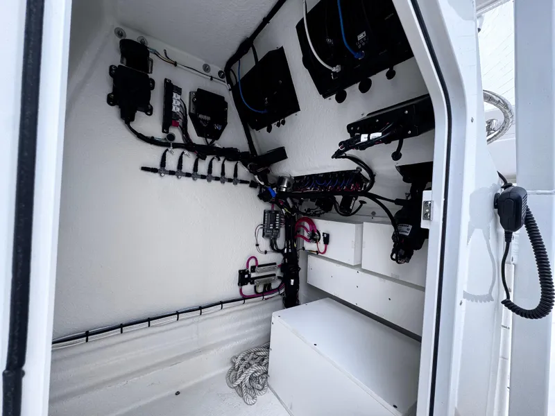 Slide: The Image of Interior view of 2025 Pair Customs 24DV boat, showcasing electrical systems and wiring. - 13