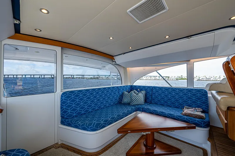 Slide: The Image of Luxurious 2017 F&S Custom Express Sportfish yacht interior with blue seating and wooden table. - 36