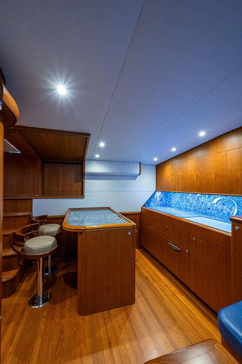 Slide: The Image of 2017 F&S Custom Express Sportfish interior with wood finish and blue accents. - 42