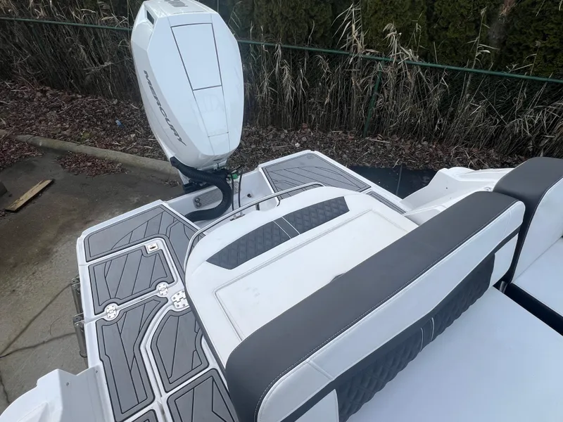 Slide: The Image of 2024 Monterey 255 Super Sport boat with sleek seating and modern outboard motor. - 2