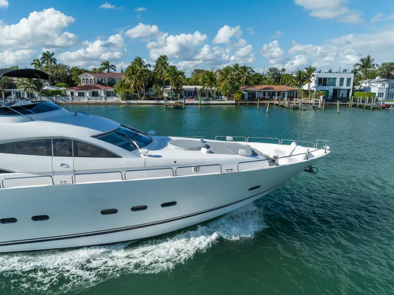 Slide: The Image of Luxury Sunseeker 150 GT yacht cruising near waterfront homes, 2003 model. - 11