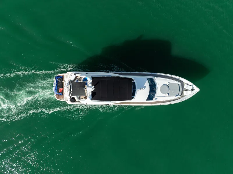 Slide: The Image of Aerial view of 2003 Sunseeker 150 GT yacht cruising on green water. - 14