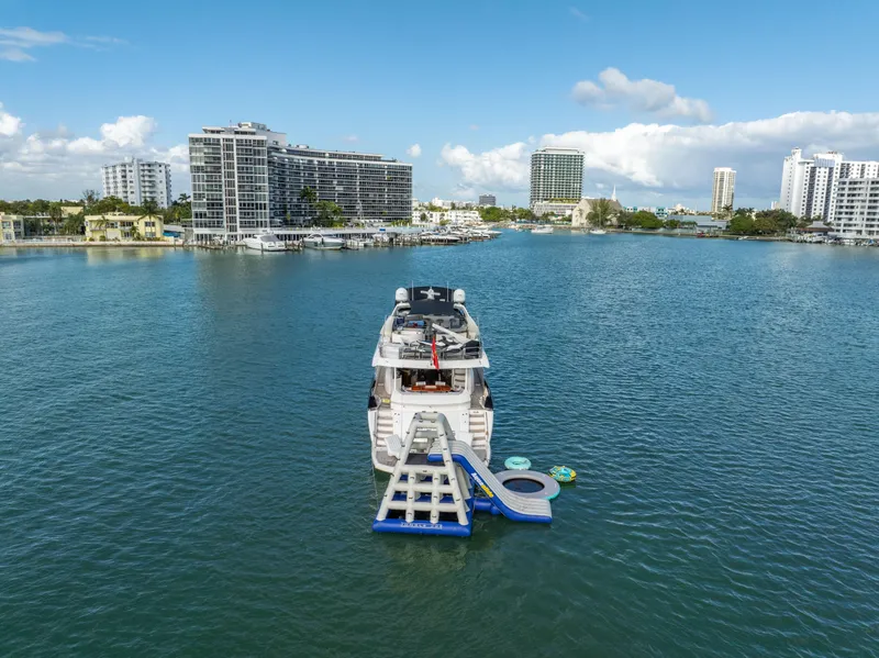 Slide: The Image of Sunseeker 150 GT yacht with water slide, 2003 model, in a scenic urban marina. - 18