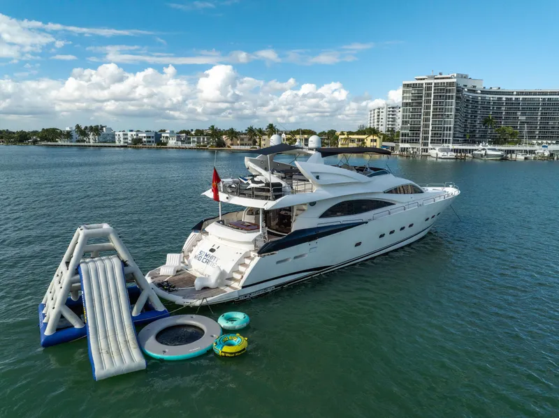 Slide: The Image of Sunseeker 150 GT yacht with water slide and inflatables, 2003 model, docked near modern buildings. - 19