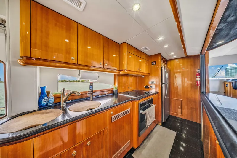 Slide: The Image of Luxurious kitchen interior of 2003 Sunseeker 150 GT yacht with wooden cabinetry. - 34