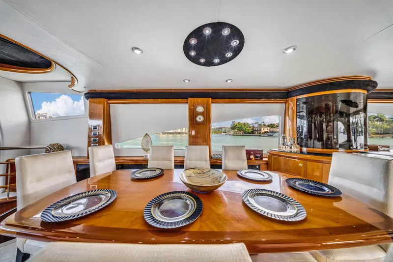 Slide: The Image of Luxurious dining area on a 2003 Sunseeker 150 GT yacht with elegant table settings. - 36