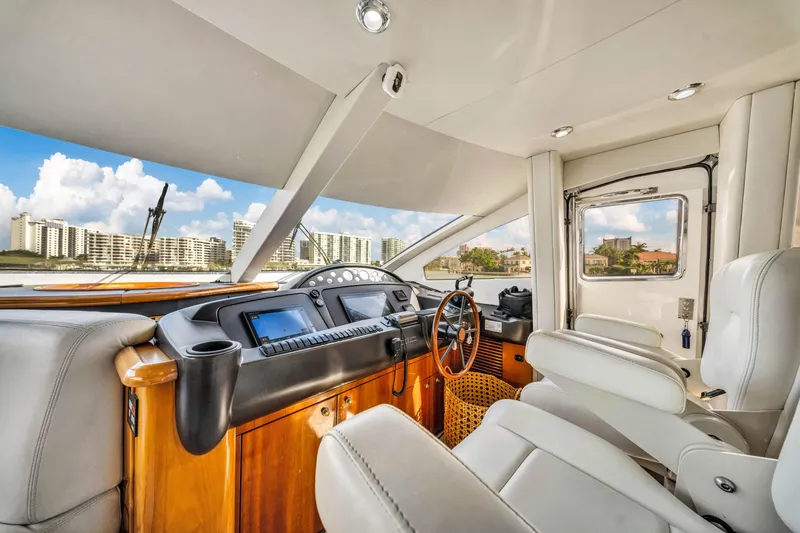 Slide: The Image of Luxurious interior of 2003 Sunseeker 150 GT yacht with modern dashboard and plush seating. - 38