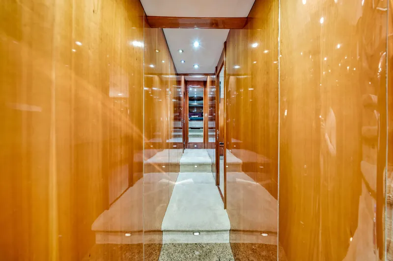 Slide: The Image of Luxurious wooden hallway interior of 2003 Sunseeker 150 GT yacht, featuring elegant lighting. - 46