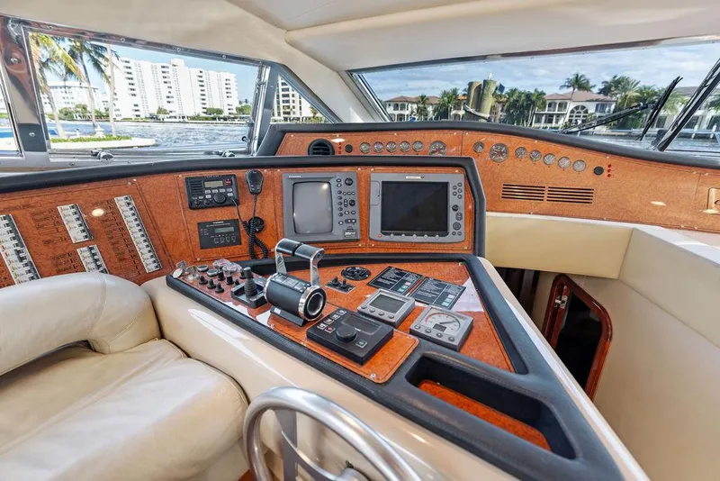 Slide: The Image of Luxurious 2003 Ferretti Yachts 620 helm with advanced navigation controls and panoramic view. - 27