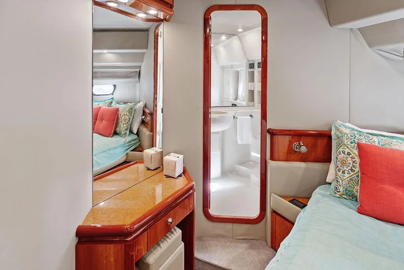 Slide: The Image of Luxurious 2003 Ferretti Yachts 620 cabin interior with elegant wood finishes and cozy bedding. - 33