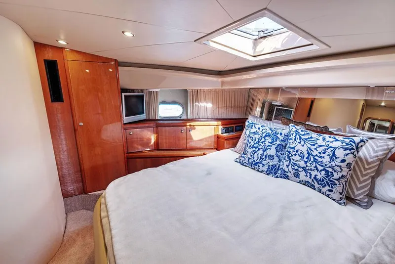 Slide: The Image of Luxurious bedroom interior of 2003 Ferretti Yachts 620 with elegant bedding and wood finishes. - 40