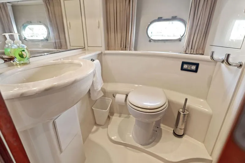 Slide: The Image of Luxurious bathroom in 2003 Ferretti Yachts 620, featuring modern fixtures and porthole window. - 43