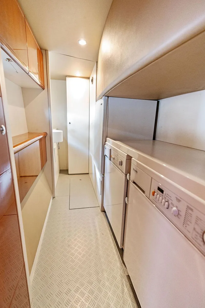 Slide: The Image of Laundry area in 2003 Ferretti Yachts 620, featuring washer and dryer. - 45