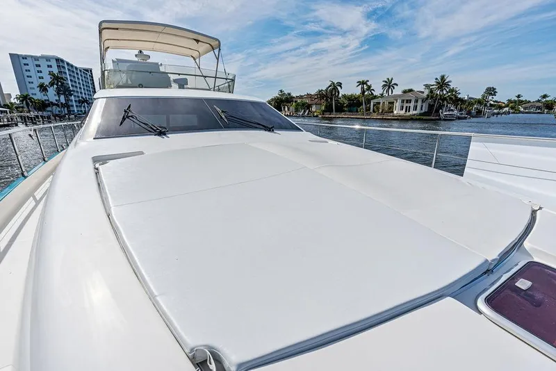 Slide: The Image of 2003 Ferretti Yachts 620 on water, showcasing sleek deck design and luxurious features. - 11